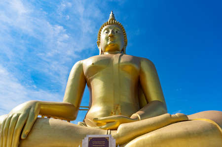 Great Buddha of Thailand, big golden sitting Buddha statue at Wat Muang temple against blue sky on the backgroundのeditorial素材