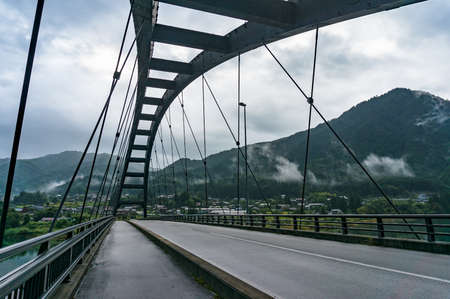 Bridge structure with view of countryside and mountains. Kiso valley, Japanのeditorial素材