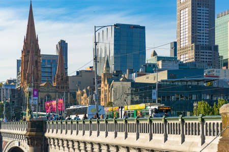 Melbourne, Australia - April 4, 2017: Tram and pedestrians on Princess Bridge with Melbourne CBD buildings on the backgroundのeditorial素材