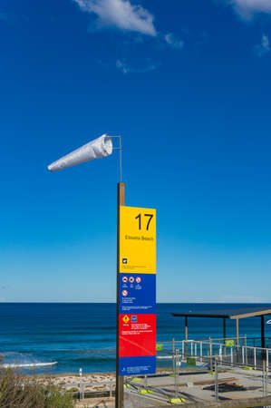 Cronulla, Australia - May 24, 2017: Windsock and information board at Elouera beach in Cronulla suburb. High wind weather on sunny weatherのeditorial素材