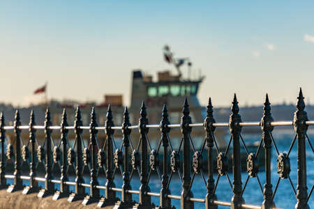 Cast iron railings at Circular Quay and ferry on the background. Selective focus on railings. Sydney, Australiaのeditorial素材