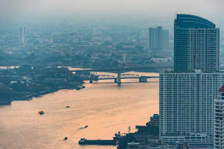 Aerial view of Bangkok and Chao Phraya river in evening haze on duskのeditorial素材