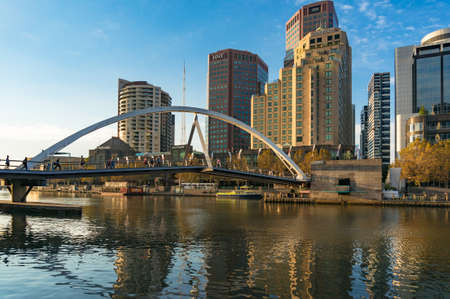 Melbourne, Australia - April 20, 2017: Evan Walker pedestrian bridge with Southbank cityscape on the...