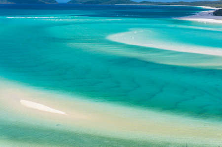 Tropical lagoon seascape of turquoise blue water and sand beach. Whitsunday, Queensland, Australiaの写真素材