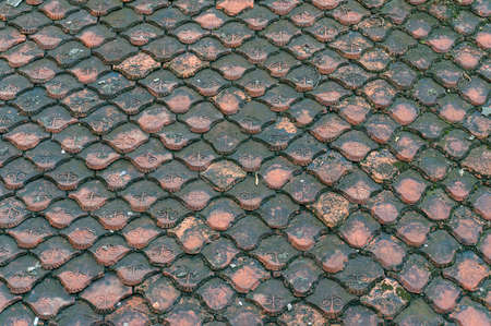 Old terracotta roof tiles pattern. Shabby background