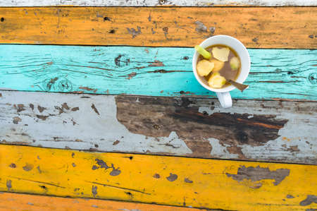 Lemongrass and ginger tea on colorful old table. Bright backgroundの写真素材