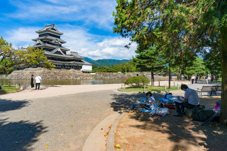 Matsumoto, Japan - September 6, 2016: Child and adult painting Matsumoto castle on sunny dayのeditorial素材