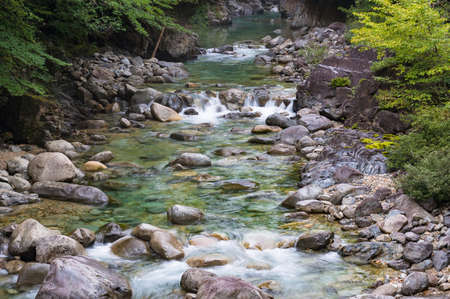 Water stream over stones. Mountain river close up. Water background