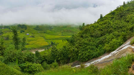 Panoramic landscape of high mountain village among rice terraces and river. Sa Pa, Vietnamの写真素材