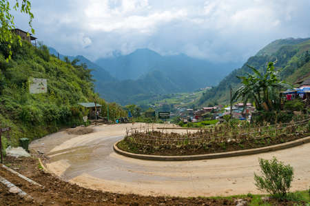 Sapa, Vietnam - August 19, 2017: Countryside road with picturesque valley and Cat Cat village on the backgroundのeditorial素材