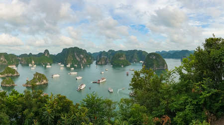 Aerial landscape of cruise boats and mountain islands in UNESCO world heritage site Halong Bay, Vietnamの写真素材