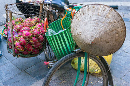 Bicycle with traditional Vietnamese hat and basket of dragonfruits. Vietnamの写真素材