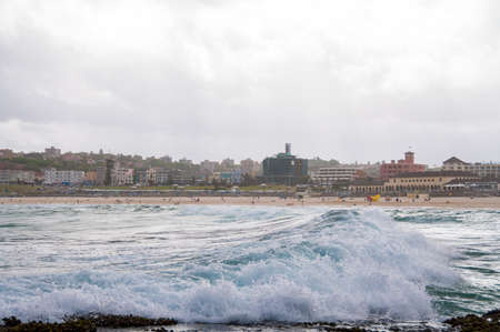Ocean wave with Bondi Beach on the background. Popular tourist destination backgroundの写真素材