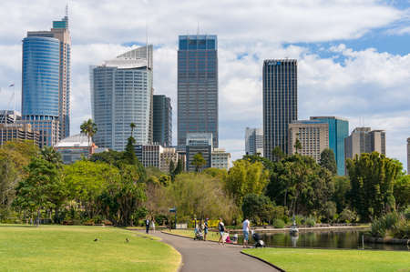 Sydney, Australia - September 23, 2017: People walking the alley in Royal Botanic Garden with Sydney CBD skyline on the backgroundのeditorial素材