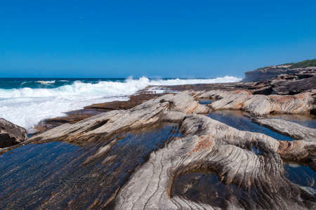 Picturesque rock surface and sea view on sunny day. Nature background