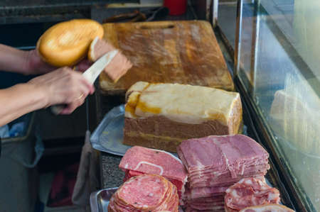 Preparing banh mi, asian bread roll, sandwich with meat and pate. Food background with motion blur