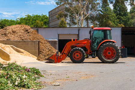 Construction site with bulldozer and pile of sand