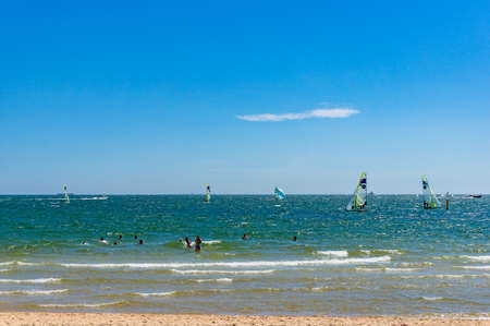 Melbourne, Australia - December 7, 2016: People enjoying summer beach holiday, rafting and swimming...
