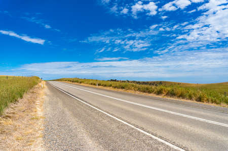 Asphalt road on sunny day. Transport infrastructure backgroundの写真素材