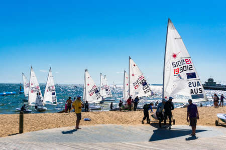 Melbourne, Australia - December 7, 2016: Sportsmen caring sailing boats after competition on St....