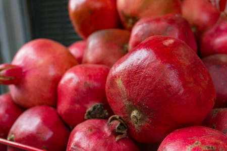 Bright red, ripe pemmegranetes close up. Fresh fruit background