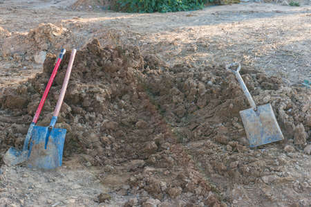 Pile of dirt, soil and shovels. Construction, digging scene