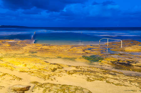 Ocean rock pool and beach at night nature background. Long exposureの写真素材