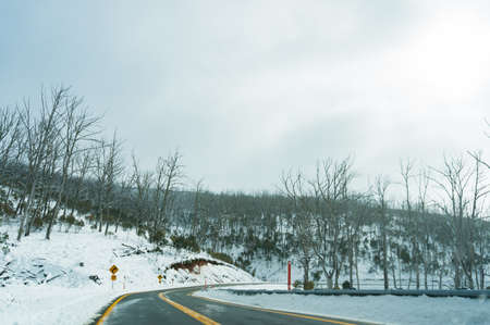 Winter landscape with winding road covered with snow. Transportation in winter landscapeの写真素材