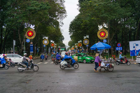 Ho Chi Minh City, Vietnam - August 23, 2017: Moving traffic crossing the street during rush hour in HCMC in Vietnamのeditorial素材