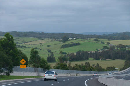 Highway with cars and road signs. Road trip in Australia background