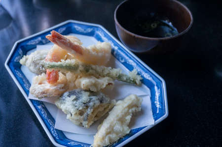 Tempura prawns and fish served with soy sauce in Japanese restaurant. Food close up backgroundの写真素材