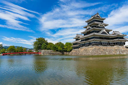 Matsumoto castle landscape with red bridge. Nagano, Japan