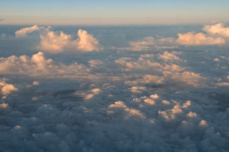 Colorful sunset clouds. View from above. Flight travel background
