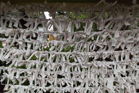Tokyo, Japan - August 29, 2016: Paper strings with prayers tied in knots. Japanese culture backgroundの写真素材