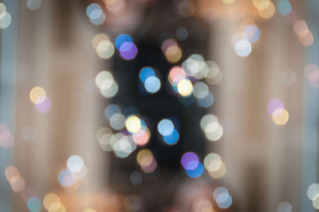 Abstract light bokeh festive background. Blurred defocused sparkle backdrop