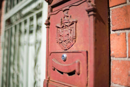 Red post box, letterbox with Swiss heraldic coat of arms