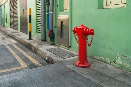 Red hydrant booster, fire hydrant on the street. Public safety urban sceneの写真素材