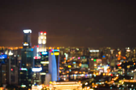 Abstract bokeh background of urban cityscape at night. Defocused, blurry image of city lights at nightの写真素材