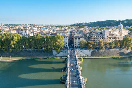 Castle of the Holy Angel bridge with people and Rome historic centre. View from above. All identifiable faces and trademarks are blurredの写真素材