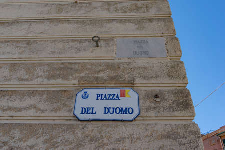 Orbetello, Italy - September 22, 2013: Street sign indicating Piazza del Duomo, Cathedral Square. Tourist and urban navigation in the historic city of Orbetello, Italyの写真素材