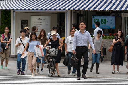 Tokyo, Japan - August 30, 2016: Japanese office workers and tourists crossing the road at pedestrian crossingのeditorial素材
