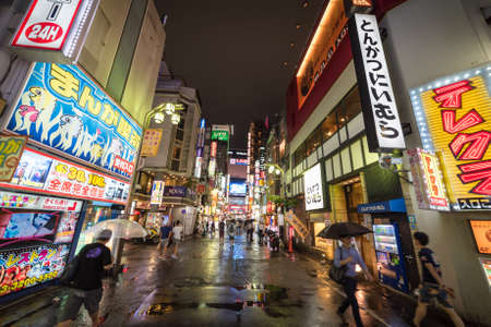 Tokyo, Japan - August 29, 2016: Night life in Shinjuku suburb of Tokyo. Ad signs in kanji...