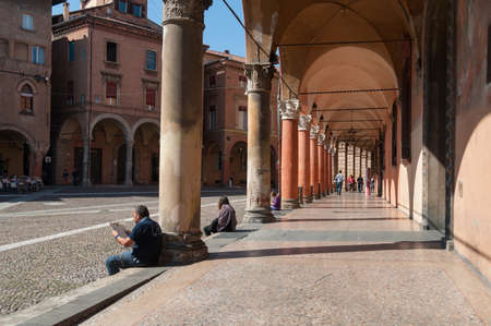 Bologna, Italy - September 26, 2013: Old street archway with classic columns and stone floor. People in Bolognaのeditorial素材