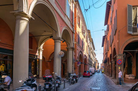 Bologna, Italy - September 26, 2013: Narrow European Italian street with medieval architecture and vehicles. Tourism Bolognaのeditorial素材