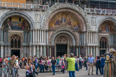 Venice, Italy- September 27, 2013: Tourists on St Mark Square in front of St Mark Cathedral taking photos and enjoying themselvesのeditorial素材