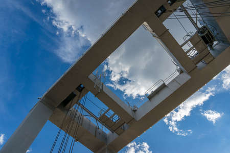Abstract insudtry, construction background of white metal construction frame against blue sky on the...