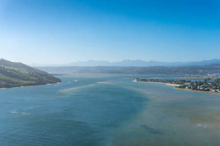 Aerial view of blue water lagoon with mountains in the distance. Knysna, South Africa