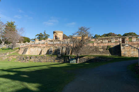 Tasmania, Australia - July 19, 2014: Landscape with ruins of historic building of The Penitentiary in Port Arthur in Tasmania, Australia. Tourists exploring historic Heritage site in Port Arthurの写真素材