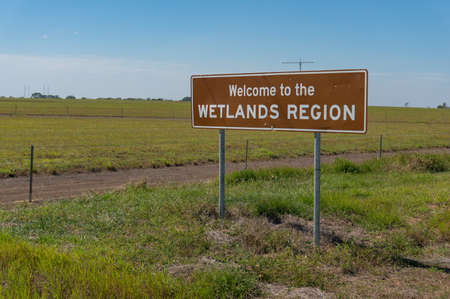 Northern Territory, Australia - June 2, 2019: Road sign at the entrance to Wetlands Region of Northern Territory, Australia. Welcome to Wetlands Region information roadsign, tourism infrastructure のeditorial素材