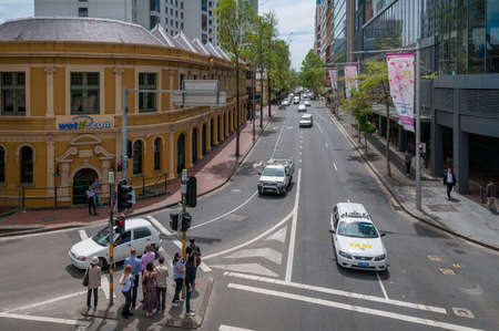 Sydney, Australia - October 10, 2014: Sussex street in Sydney CBD, Central Business District with traffic and pedestrians crossing on street lightsのeditorial素材